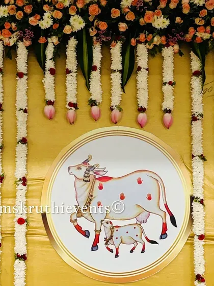 A close-up of the sacred cow and calf illustration used in our custom backdrops. This element adds a deep cultural and spiritual meaning to the event's decor.