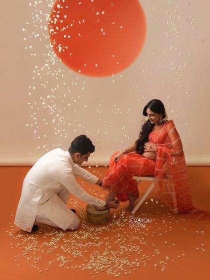 Incorporating rituals into the photoshoot adds a layer of meaning. Here, he kneels in a gesture of care, a beautiful moment that honors both his partner and their journey into parenthood.