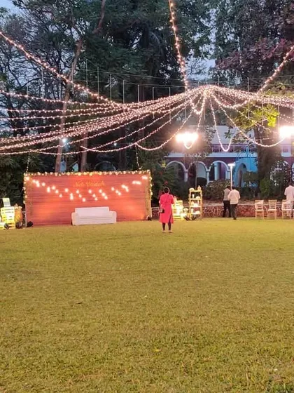 An expansive view of the lawn reception, showcasing the scale of our lighting design. The canopy of string lights covers the entire area, ensuring the space is beautifully lit and full of ambiance.