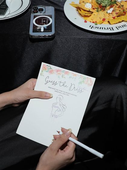 The 'Guess the Dress' game, where guests sketch what they think the bride's wedding dress will look like.