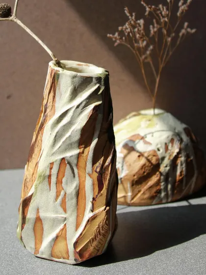 A pair of Kurinuki vases, one tall and faceted, the other round and organic. Together, they showcase the versatility of this hand-building technique.