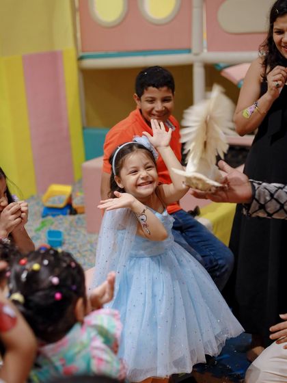 The birthday girl's face lights up with pure delight during the magic show. The appearance of a live dove is always a highlight that creates lasting memories.