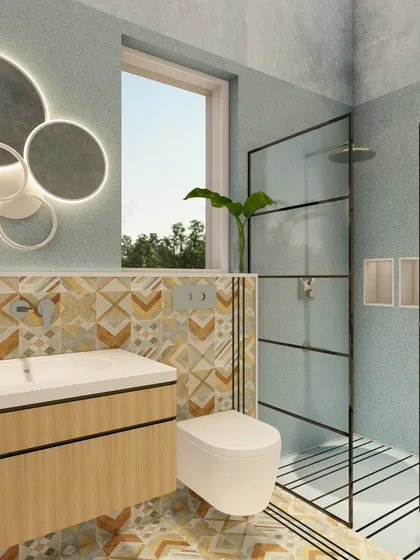 Another view of the bathroom, showing the walk-in shower with a black-framed glass door that contrasts with the light and colorful tiles. The design is fresh, modern, and full of personality.