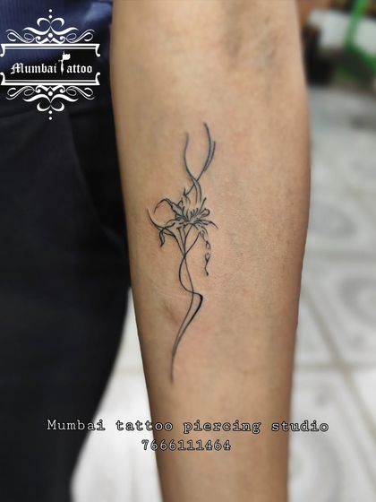 An abstract lily flower tattoo with flowing, dynamic lines. This design shows our artistic flair in reinterpreting classic floral tattoos into modern, unique pieces.