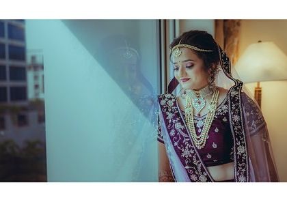 A moment of quiet reflection for the bride before the ceremony begins. The soft light from the window creates a gentle and dreamy mood.