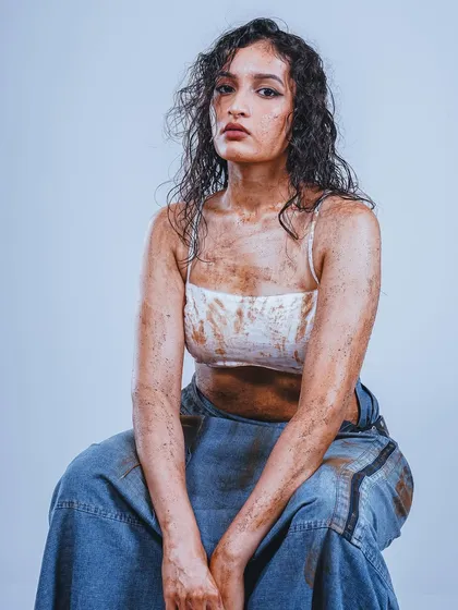 For this conceptual portrait, the goal was to create a raw and intense look. The styling with wet hair and smudged textures, combined with clean studio lighting, creates a striking image perfect for a model's portfolio or an edgy editorial.