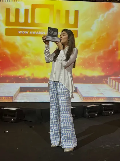 A moment of pure joy and gratitude on stage after receiving the award. This recognition fuels my drive to continue pushing creative boundaries.