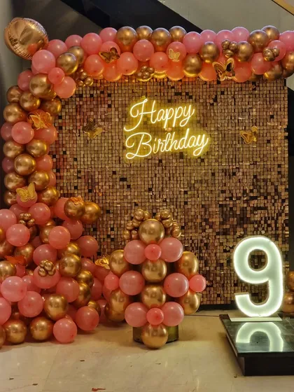A full view of the rose gold birthday party decorations.
