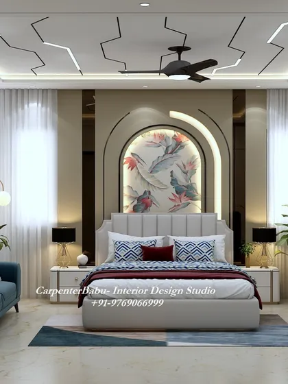 A luxurious master bedroom with a unique false ceiling design that mimics lightning. The headboard wall features a beautiful floral mural within an arched niche.