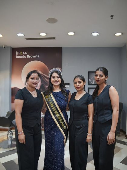 A picture of our client with some of my talented female staff members. It highlights the skilled team that is here to provide you with the best service and experience.