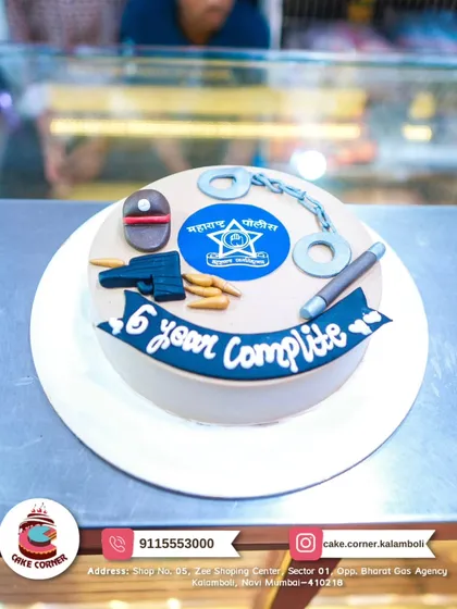 A cake celebrating 6 years of service in the Maharashtra Police. It features the police logo, handcuffs, and a baton, honoring their dedication.