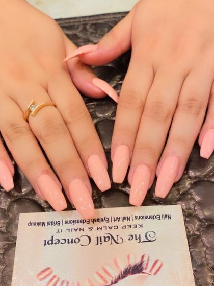 A simple and clean set of long, coffin-shaped nails in a solid peach color. This is a warm and versatile shade that looks great on any skin tone.