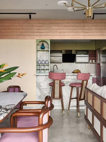 The open-plan layout connects the dining area to the breakfast bar and kitchen. I used curved geometry and textured paint to frame the kitchen area, creating a distinct yet connected zone.