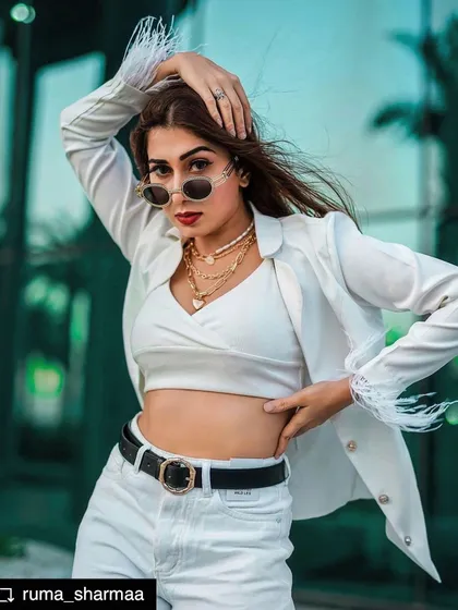 Styling is about versatility. Here, I created a powerful 'boss babe' look with a structured white blazer featuring feather-cuff details, paired with a crop top and layered necklaces for a chic, modern edge.