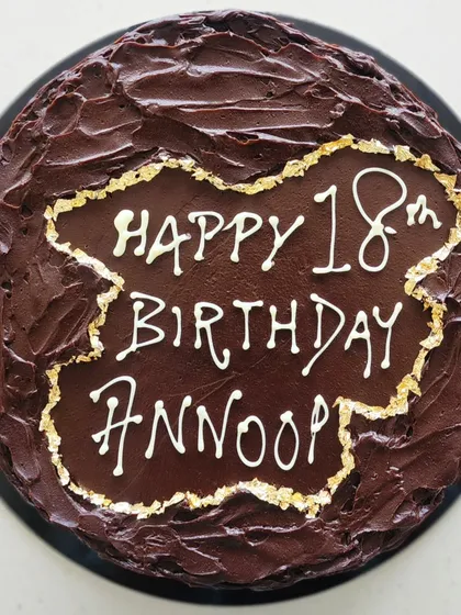 I made this rich dark chocolate ganache cake for a special 18th birthday. The rustic, textured chocolate finish with delicate gold leaf edging is one of my signature styles for milestone celebrations.