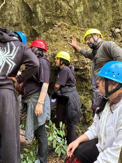 Our group getting ready to enter the caves, equipped with helmets. Safety and adventure go hand in hand on our guided explorations.