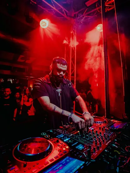 A close-up of me mixing under intense red light at The Kai Room in Gurugram.