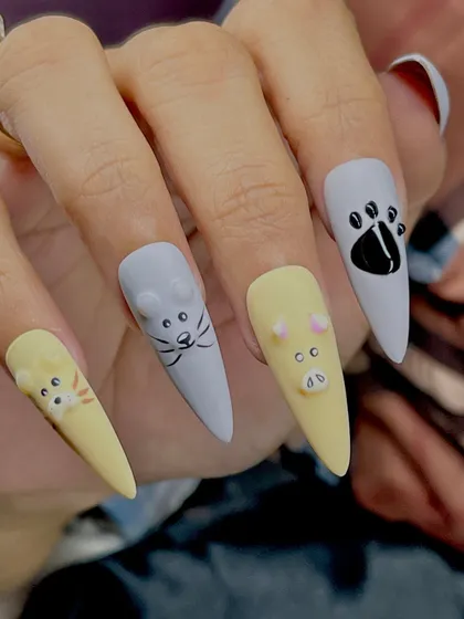 A model wearing the cute embossed animal nail art, showing how these designs look in a real-world setting.