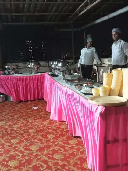 A rooftop catering setup for an evening event. The pink table skirting adds a bit of colour to the arrangement.