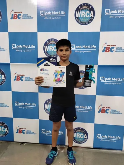Our young champion posing with his certificate and trophy, a testament to his hard work and our coaching.