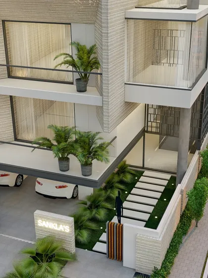An aerial view of the entrance, showing the relationship between the building, the parking area, and the landscaped entry sequence.