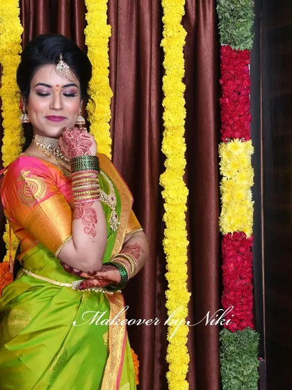 A complete look at Nirosha's engagement style. She wore a vibrant silk saree, and we created a soft glam look with a pretty pink lip and a chic updo.
