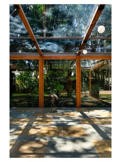 The dappled sunlight on the floor showcases the 'Komorebi' effect that inspired the pavilion's design.