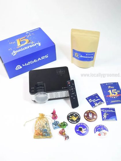 A custom anniversary kit for 42Gears' 15th year. This unique gift includes a portable projector, custom badges, and other fun items to celebrate the milestone.