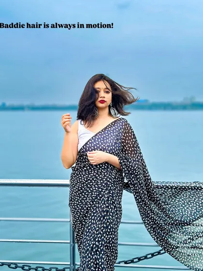 Baddie hair is always in motion! This look is for my girls who want to channel that main character energy. A simple printed black georgette saree with a white tank top is effortlessly cool and chic.