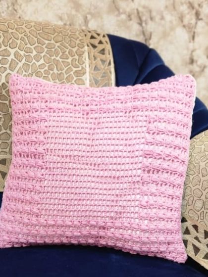 This cushion cover has a simple and elegant textured design. I used a single color of pink cotton yarn to create a lovely pattern that feels as good as it looks.