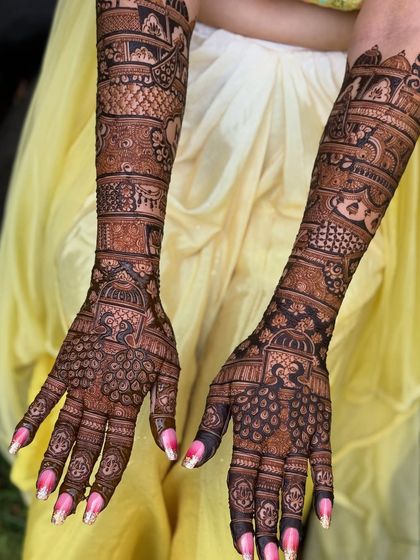A full-sleeve bridal mehendi with stunning peacock motifs on the palms. The level of detail in the feathers and surrounding patterns is what makes this design special.