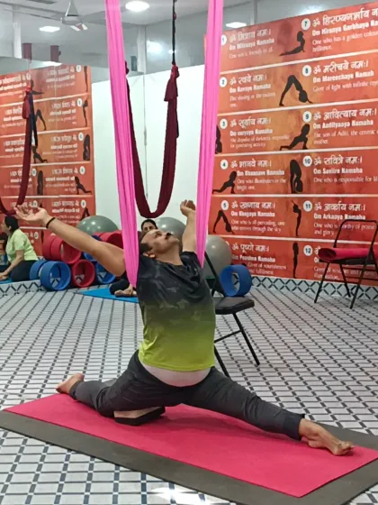 A student demonstrates a supported split using the aerial hammock. This is a fantastic way to increase flexibility in the hamstrings and hip flexors.