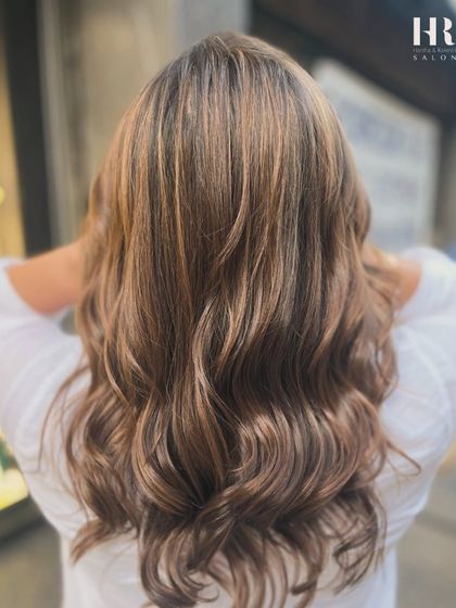 This balayage focuses on creating a bright, sun-kissed effect with warm, honey tones throughout.
