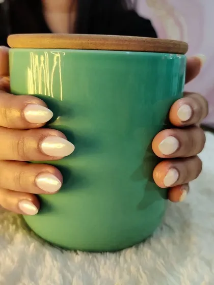 Holding a mug to show off these gorgeous glazed donut nails. The chrome finish is just perfect.