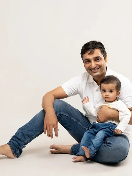 A proud father holds his little one. Our studio portraits are perfect for capturing the special, quiet bond between a parent and their child in a classic and lasting way.