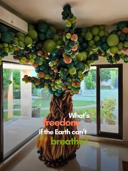 This balloon tree sculpture, installed indoors, is not just a decoration but a statement. It asks the question, "What's freedom, if the Earth can't breathe?", tying our art to our sustainability mission.