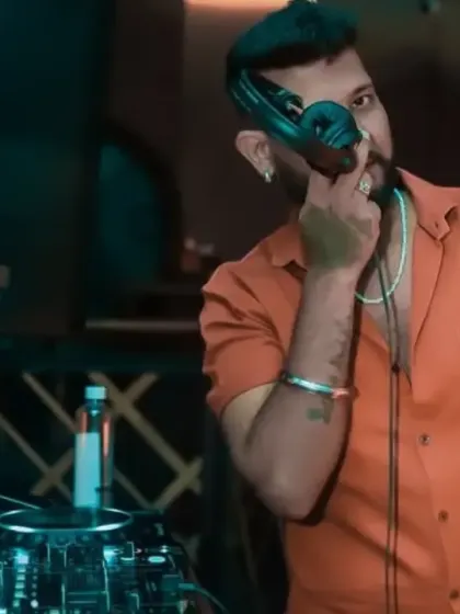 Taking a call on the headphones. Always connected, always listening to the vibe of the room.