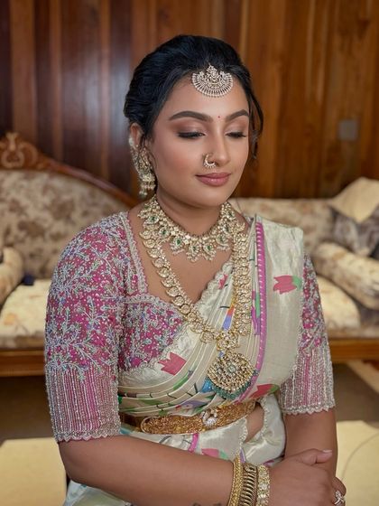 The client's eyes are closed, showing the soft, shimmery eyeshadow work in detail.