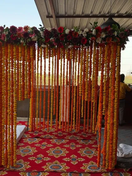 A straight-on view of the traditional marigold mandap, ready for the wedding ceremony.