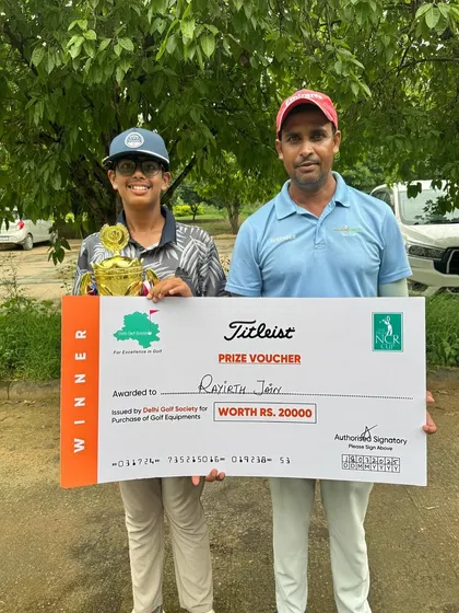A proud moment as Rayirth Jain poses with his coach and his winner's prize after a successful tournament at the 20th NCR Cup.