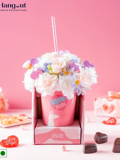 This Valentine's Day hamper includes five heart-shaped almond chocolates in a ceramic sipper decorated with artificial flowers. It's a beautiful arrangement that brings a sense of purity and devotion.