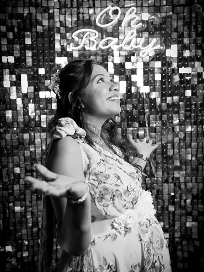 A timeless black and white version of a joyful moment. The mother-to-be's expression of pure happiness is the focus, showing the overwhelming feeling of being celebrated and loved.