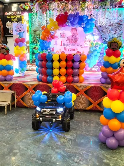 A fun addition to the Cocomelon birthday party, with a toy car decorated with balloons right in front of the stage.