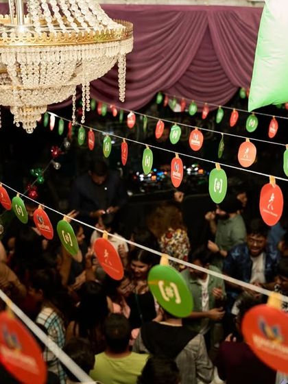 A unique angle showing the party from below the festive decorations.