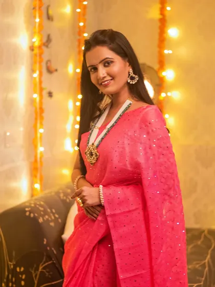 A classic three-quarter portrait. The model's pink saree and beautiful necklace are the stars of this shot.
