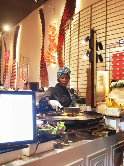 Our diverse team brings global flavours to life, like at this live grill station where guests can watch their food being cooked to perfection.