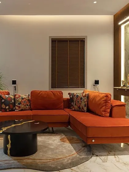 The comfortable and colorful orange sectional sofa, custom-made to fit the client's family lounge and reflect their love for vibrant hues.