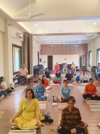 A wider view of the Pranayama workshop, showing the spacious and well-lit hall. The environment is designed to be calm and conducive to deep, focused practice and learning.