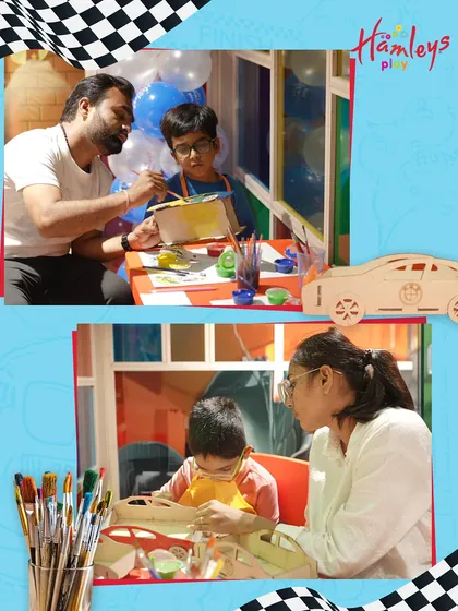 Parents are always welcome to join the fun! Here, a father and son work together on a car-painting project, making it a wonderful family bonding activity during our Mini Racers event.