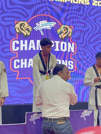 Karan Betageri on the podium after winning Gold at the Champion of Champions Final 2024.